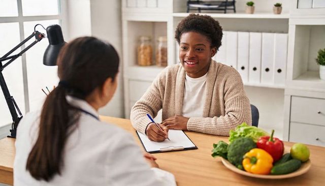 Nutrition consultation: patient holding clipboard during friendly clinic visit