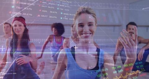 Smiling woman leading group fitness class with financial data overlay and stock charts