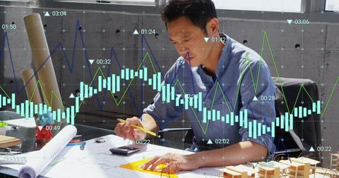 Architect Working with Blueprints and Financial Data Overlay