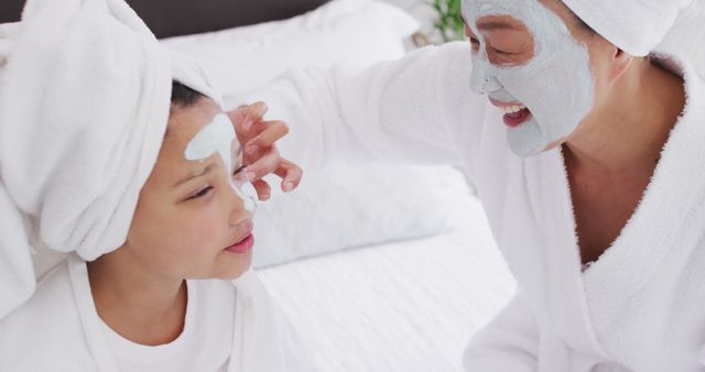 Mother and daughter enjoying home spa treatment with facial masks - Download Free Stock Images Pikwizard.com