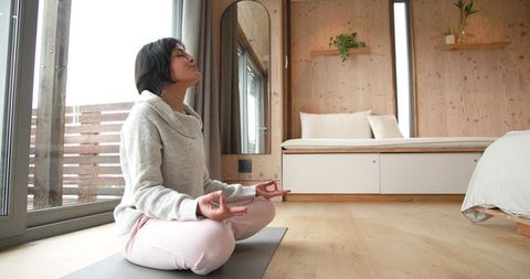 Mindful meditation in peaceful wooden cabin interior