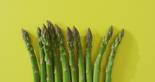 Image of fresh asparagus with copy space over green background. fusion food, fresh vegetables and healthy eating concept.