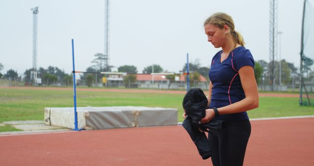 Female athlete preparing for track and field training - Download Free Stock Images Pikwizard.com