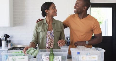Couple Engaging in Home Recycling Together, Smiling and Teamwork