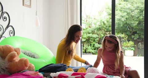 Mother and Daughter Packing for Vacation Filled with Joy