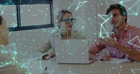 Business team collaborating over laptop with holographic network overlay for tech strategy