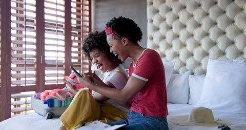 Diverse Female Couple Packing for Exciting Getaway