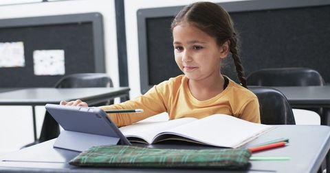 Young Student Engaged with Tablet in Classroom