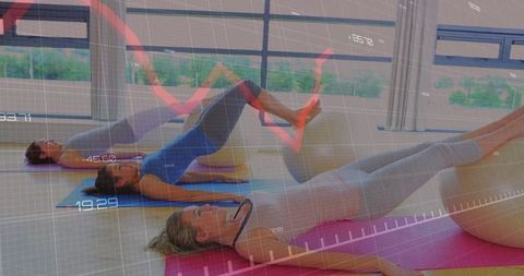 Women exercising with stability balls overlaying data graphics