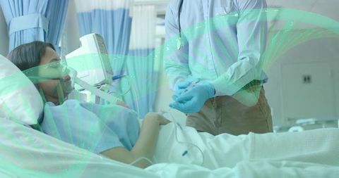 Caregiver adjusting iv and oxygen for patient resting in hospital bed with monitor