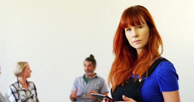 Portrait of Redhead Young Woman Holding Tablet in Office Environment - Download Free Stock Images Pikwizard.com