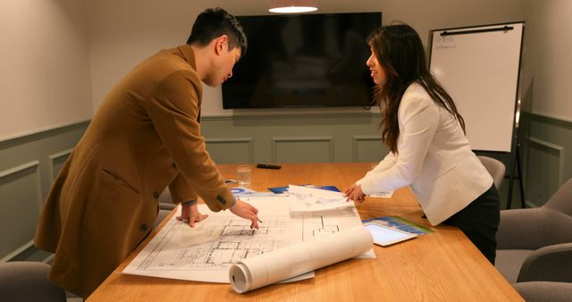 Two Architects Collaborating on Project with Blueprints in Modern Office - Download Free Stock Images Pikwizard.com