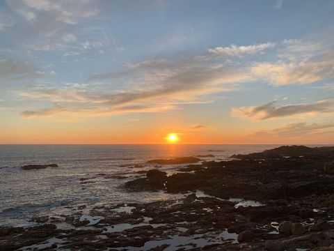 Breathtaking Coastal Sunset Over Rugged Shoreline