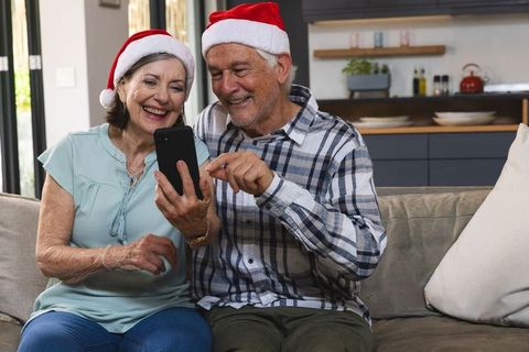 Senior couple enjoying christmas moments on couch