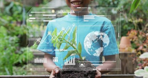 Smiling boy holding seedling with ar hud overlay teaching gardening and green skills