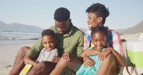 Cheerful Family Enjoying Beach Vacation Together