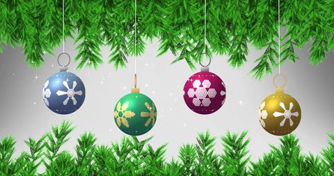 Festive christmas baubles hanging among green pine branches