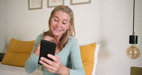 Mature Woman Enjoying Phone Relaxation at Home