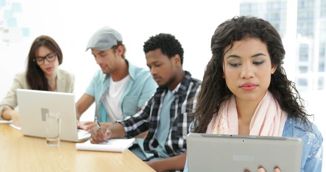 Young Professionals Collaborating with Laptops and Tablet in Office - Download Free Stock Images Pikwizard.com