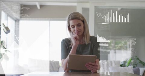 Woman Analyzing Financial Data on Digital Tablet with Graphs - Download Free Stock Images Pikwizard.com
