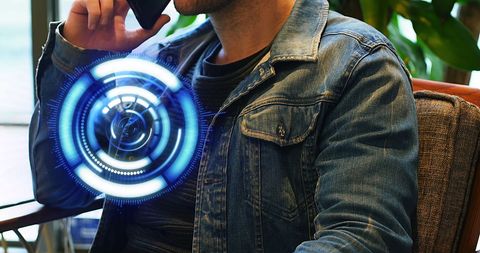 Man using smartphone with futuristic holographic display