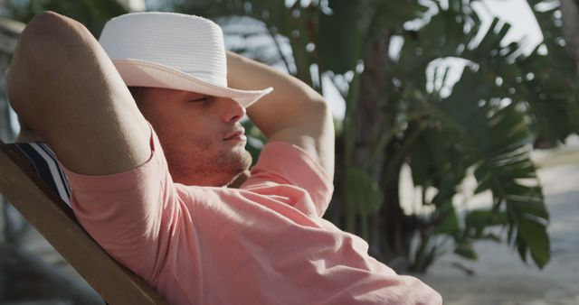 Relaxed Man Sitting on Chair Enjoying Tropical Paradise - Download Free Stock Images Pikwizard.com