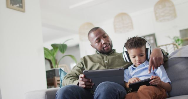 Father and Son Bonding with Digital Tablets and Headphones - Download Free Stock Images Pikwizard.com