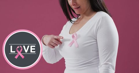 Woman Promoting Breast Cancer Awareness with Pink Ribbon and Sign