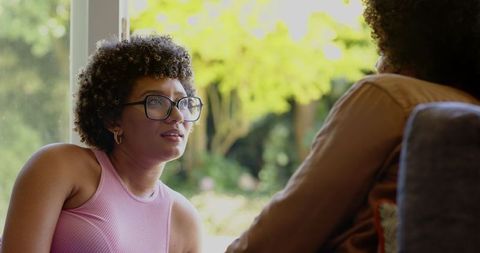 Cheerful Women Conversing Near Sunlit Window