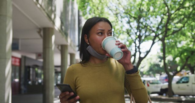 Young Woman Drinking Coffee Outside While Using Smartphone - Download Free Stock Images Pikwizard.com