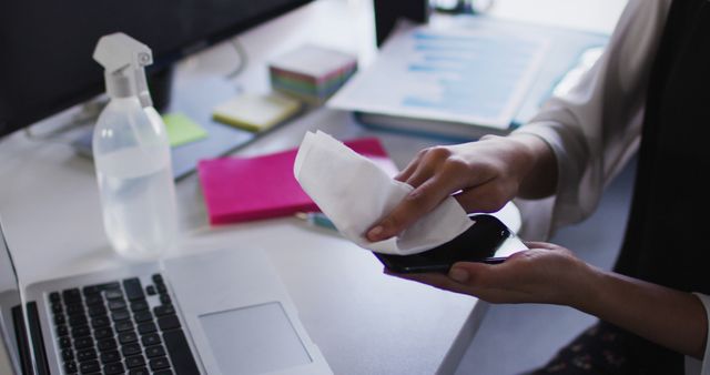 Person Sanitizing Smartphone at Desk - Download Free Stock Images Pikwizard.com