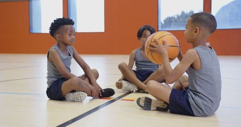 school-age friends practicing basketball in gym - Download Free Stock Images Pikwizard.com