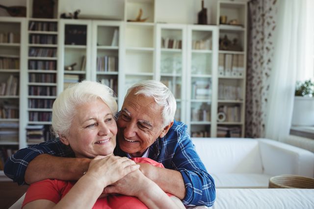 Senior Couple Embracing in Cozy Living Room - Download Free Stock Photos Pikwizard.com