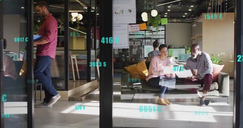 Diverse Team Collaborating in Modern Office with Financial Data