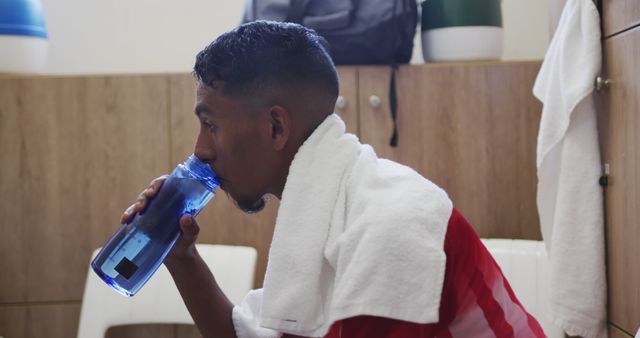 Athlete Drinking Water and Resting in Locker Room - Download Free Stock Images Pikwizard.com