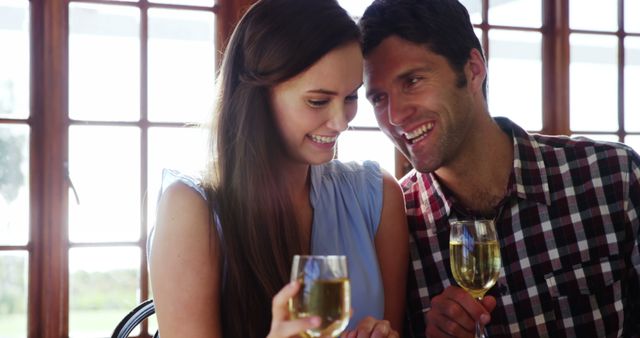 Young couple toasting champagne in restaurant