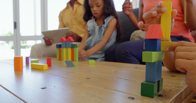 Children playing with building blocks on table in a comfortable home - Download Free Stock Photos Pikwizard.com
