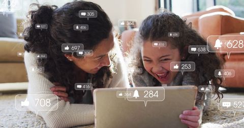 Mother and Daughter Enjoying Tablet With Social Media Icons