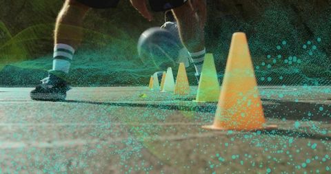 Athlete Dribbling Soccer Ball Through Cones with Digital Overlay