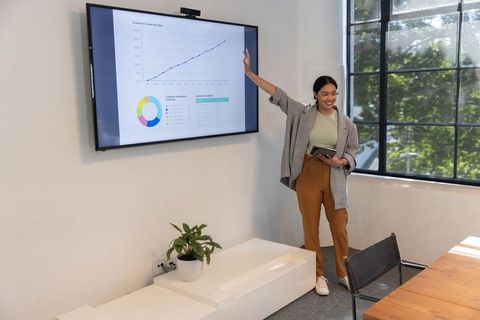 Confident businesswoman presenting in modern office workspace