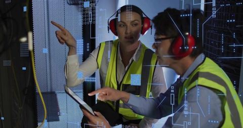 Datacenter Technicians Collaborating Kneeling with Tablet Pointing at Server Racks and AR Overlay