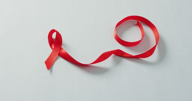 Image of red ribbon on grey background. health, prevention, medicine, symbols and cancer awareness concept.