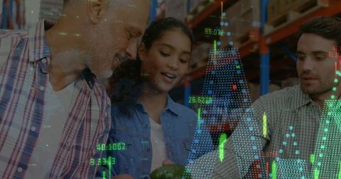 People in warehouse with financial data overlay indicating global business dynamics