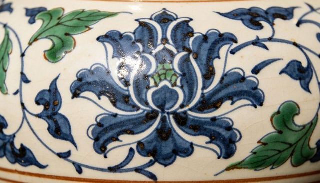 Featuring cobalt floral motif on glazed handmade ceramic vessel with craquelure detail