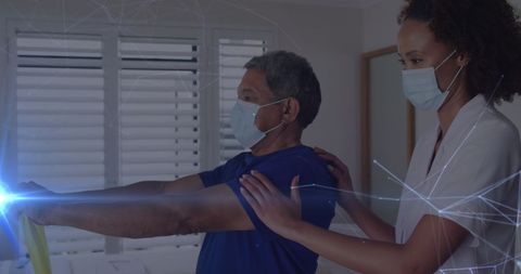 Diverse Doctor Assisting Elderly Patient with Exercise