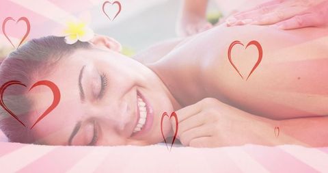 Relaxed woman enjoying spa massage with heart illustrations