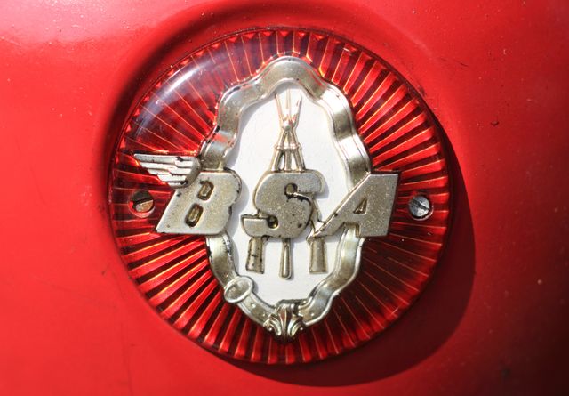 This close-up of a vintage BSA motorcycle badge captures iconic branding and classic design. Perfect for use in automotive blogs, historical articles, collector items promotions, vintage vehicle advertisements, and design inspiration boards.