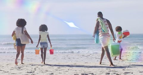Family Enjoying Sunny Beach Day with Colorful Beach Pails - Download Free Stock Images Pikwizard.com
