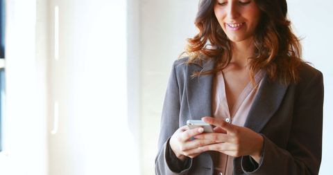 Businesswoman Using Smartphone at Office for Work Communication