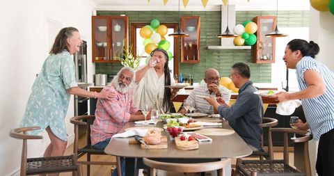 Senior Friends Enjoying Celebratory Dinner Gathering